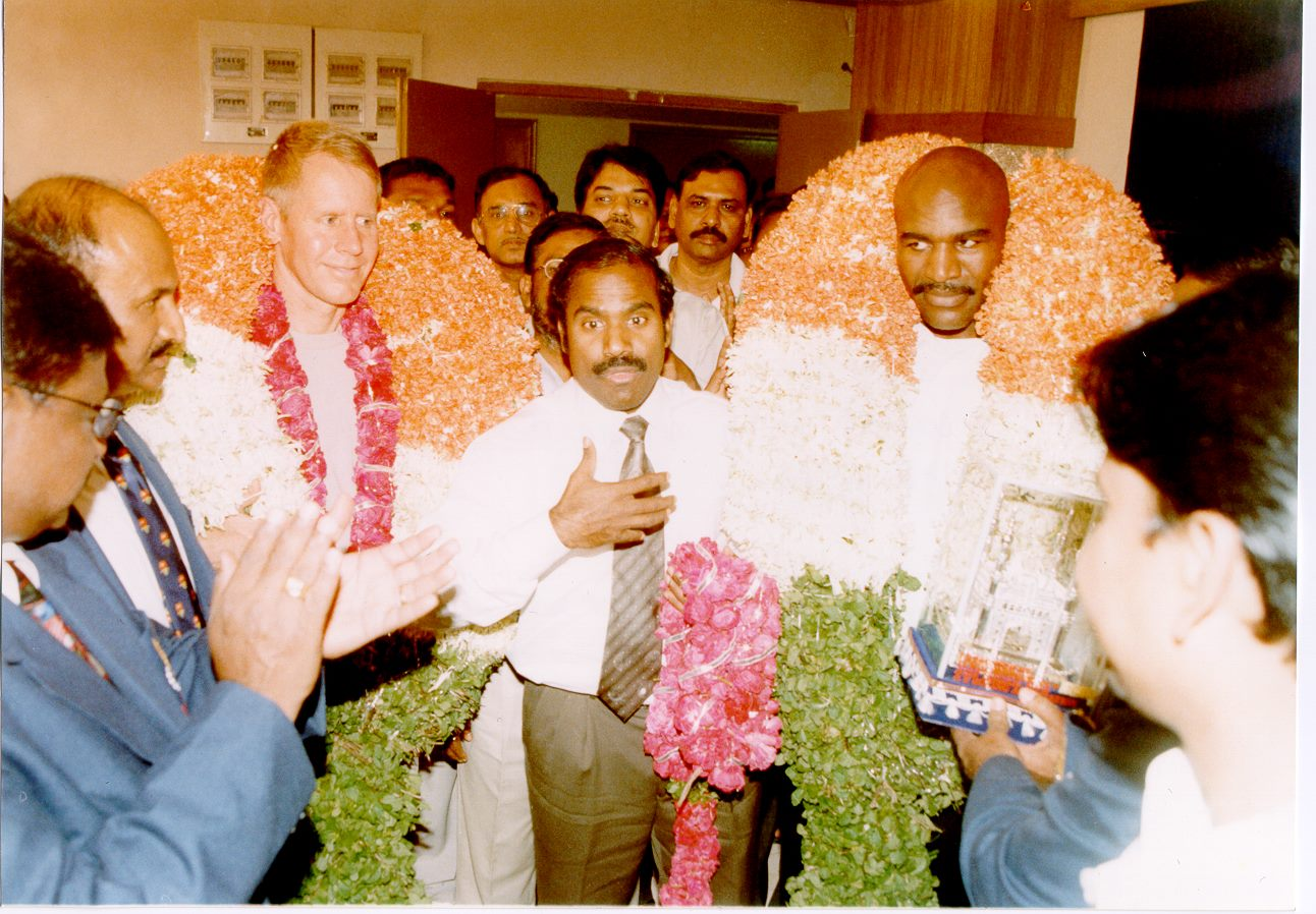 Dr. K.A. Paul welcoming honored guests with floral garlands